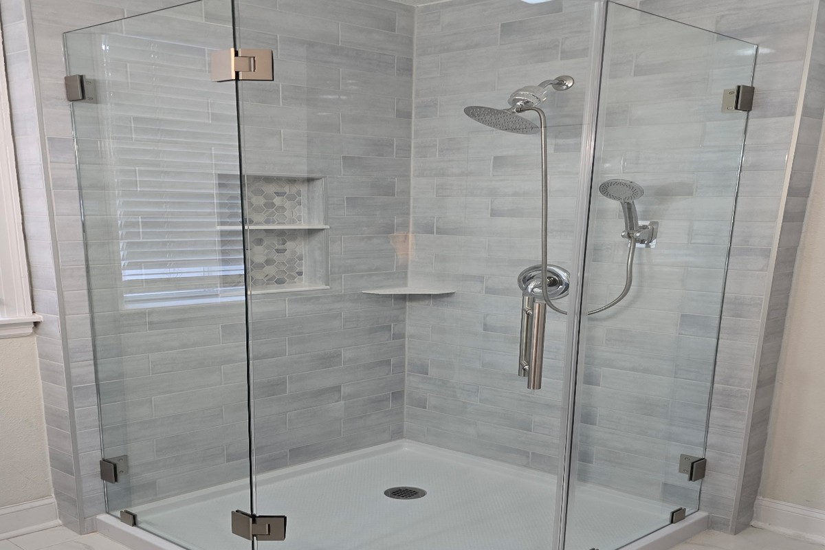 Frameless hinged glass shower enclosure