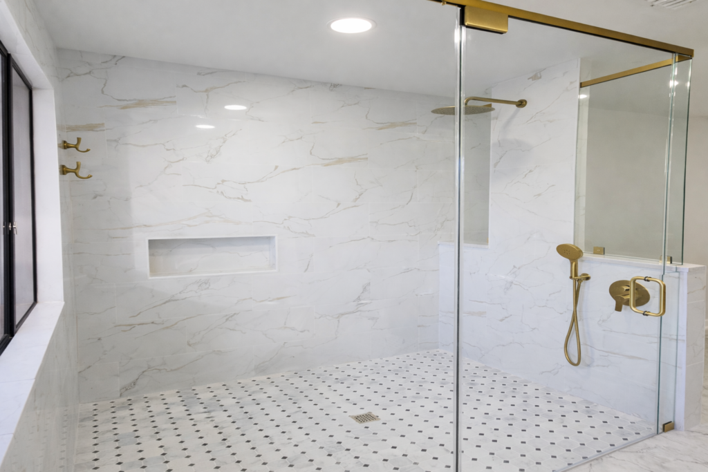 Luxury frameless glass shower with gold hardware